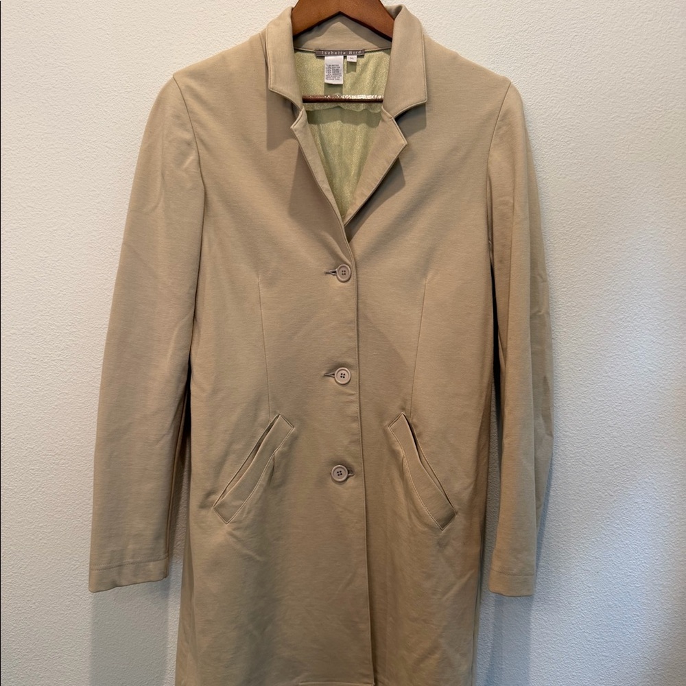 Isabella Bird tan coat.